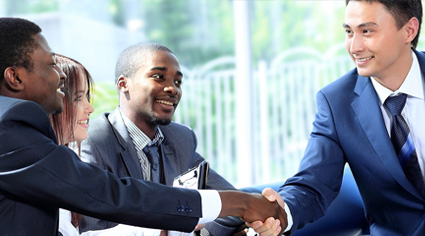 people in business suits shaking hands